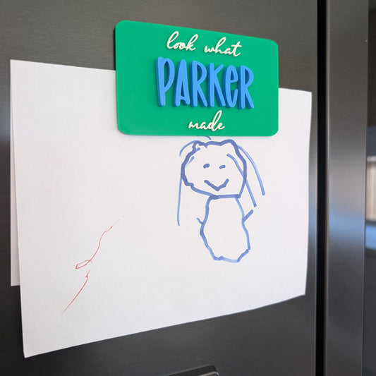 Children's drawing on a refrigerator with a 'Look what Parker made' magnet.
