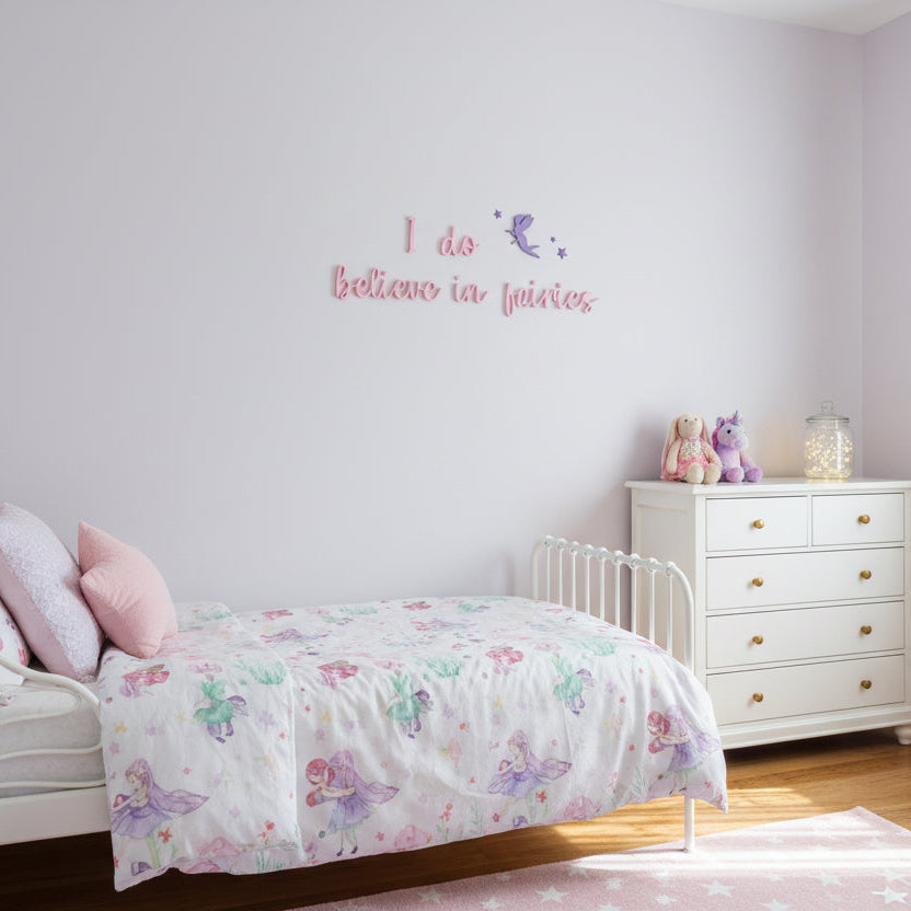 Decorative wall art with 'I do believe in fairies' text and a fairy silhouette on a light gray background.