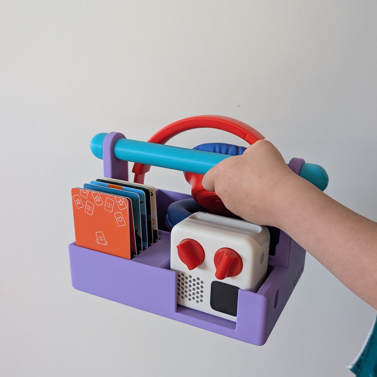 child carrying a Yoto mini in a purple carry basket