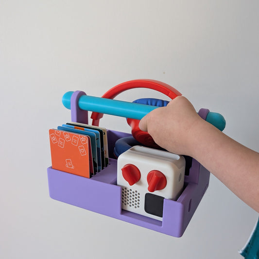 child carrying a Yoto mini in a purple carry basket