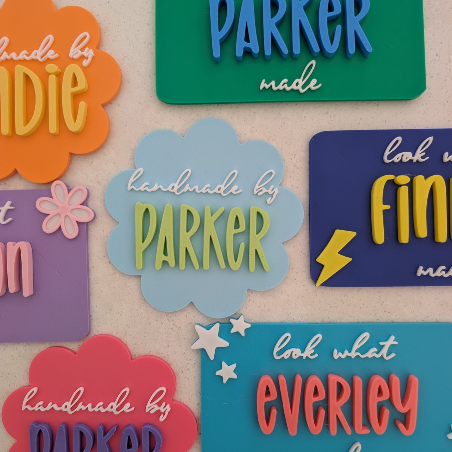 Colourful magnets with names and phrases on a beige background
