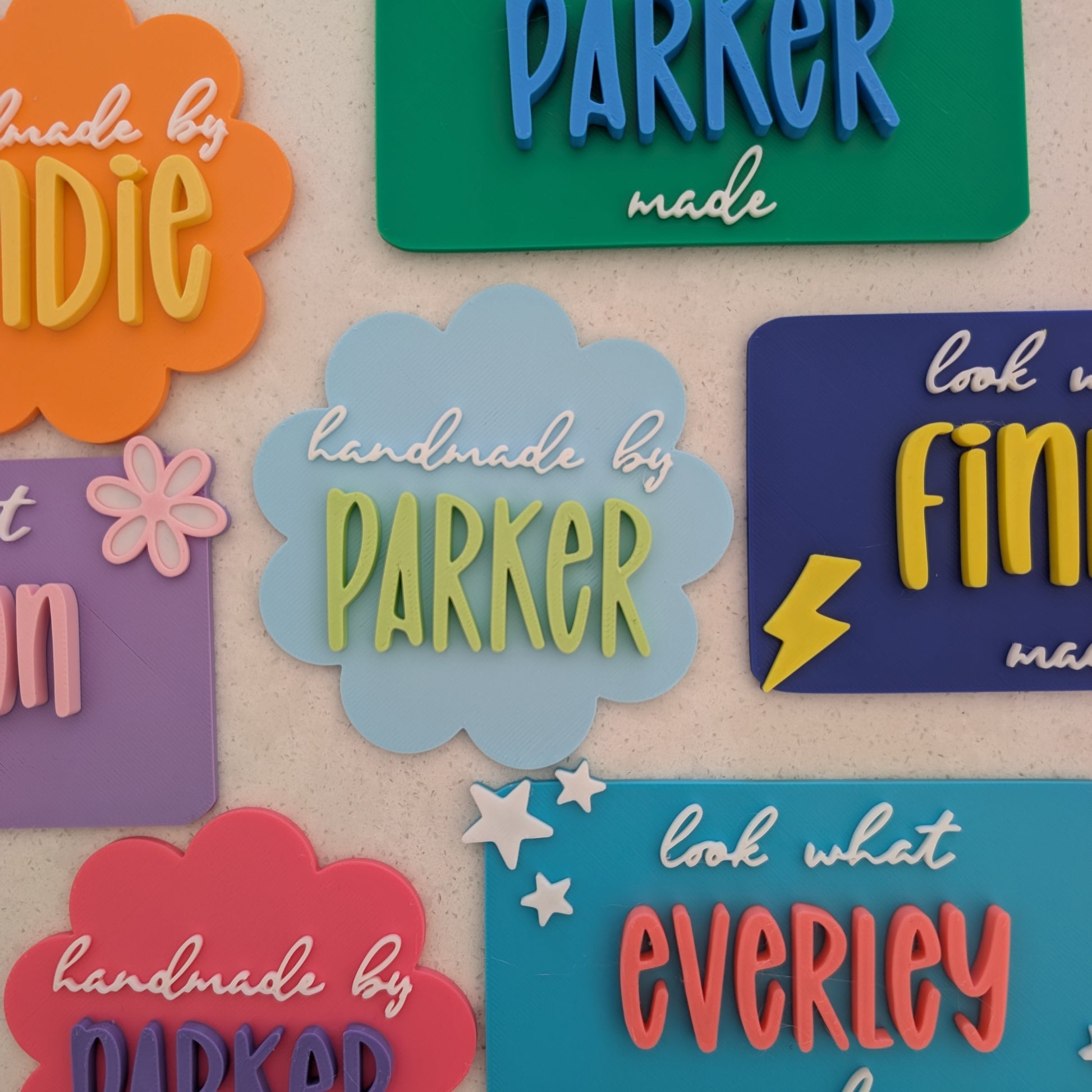 Colourful magnets with names and phrases on a beige background