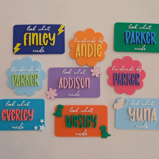 Colorful name tags with various names on a beige background