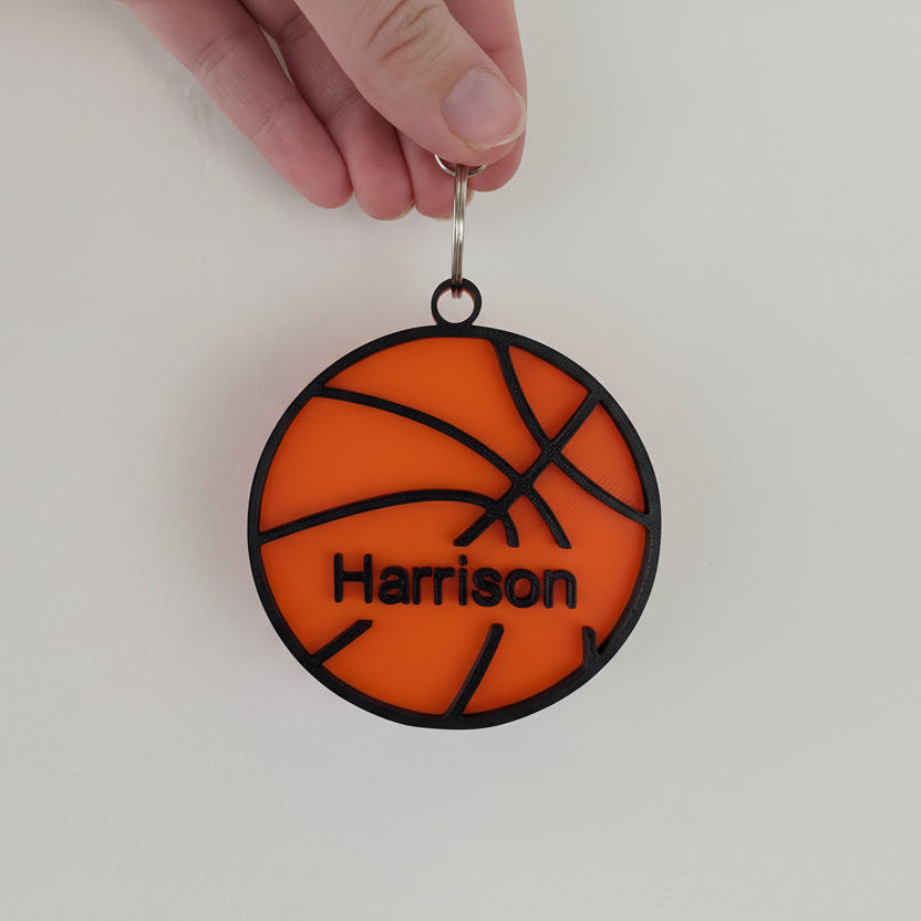 hand holding a basketball keychain