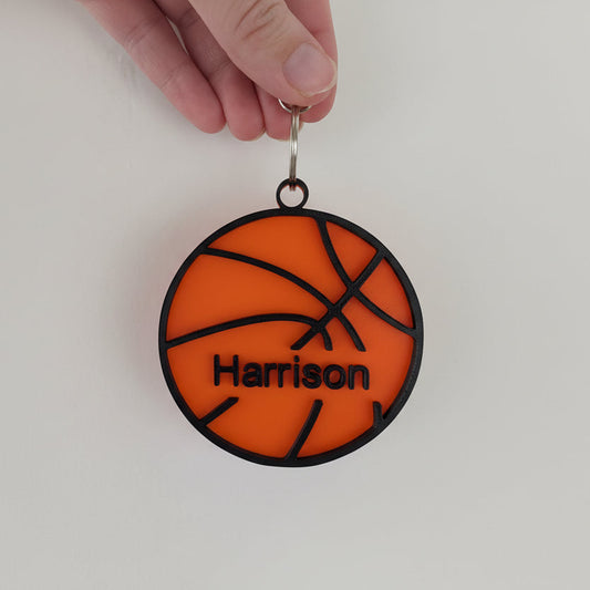 hand holding a basketball keychain