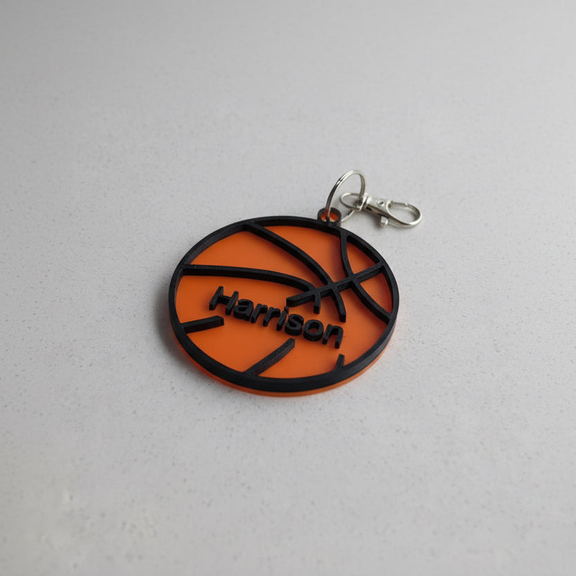 orange basketball keychain on white background