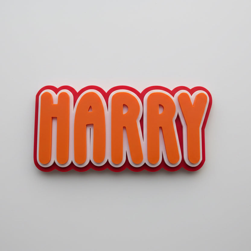 Red and orange 'HARRY' name sign on a light gray background
