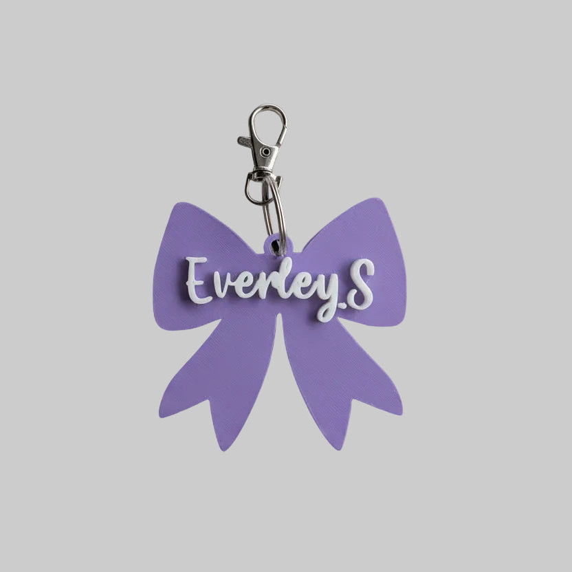 purple bow keychain with name everley.S