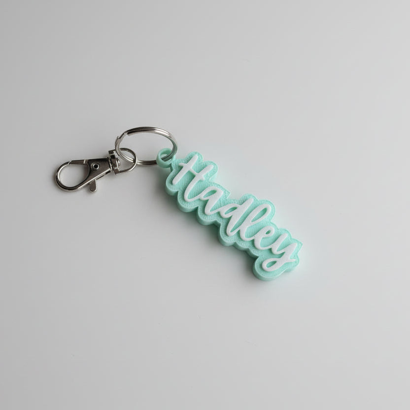 Turquoise keychain with a metal clasp on a gray background