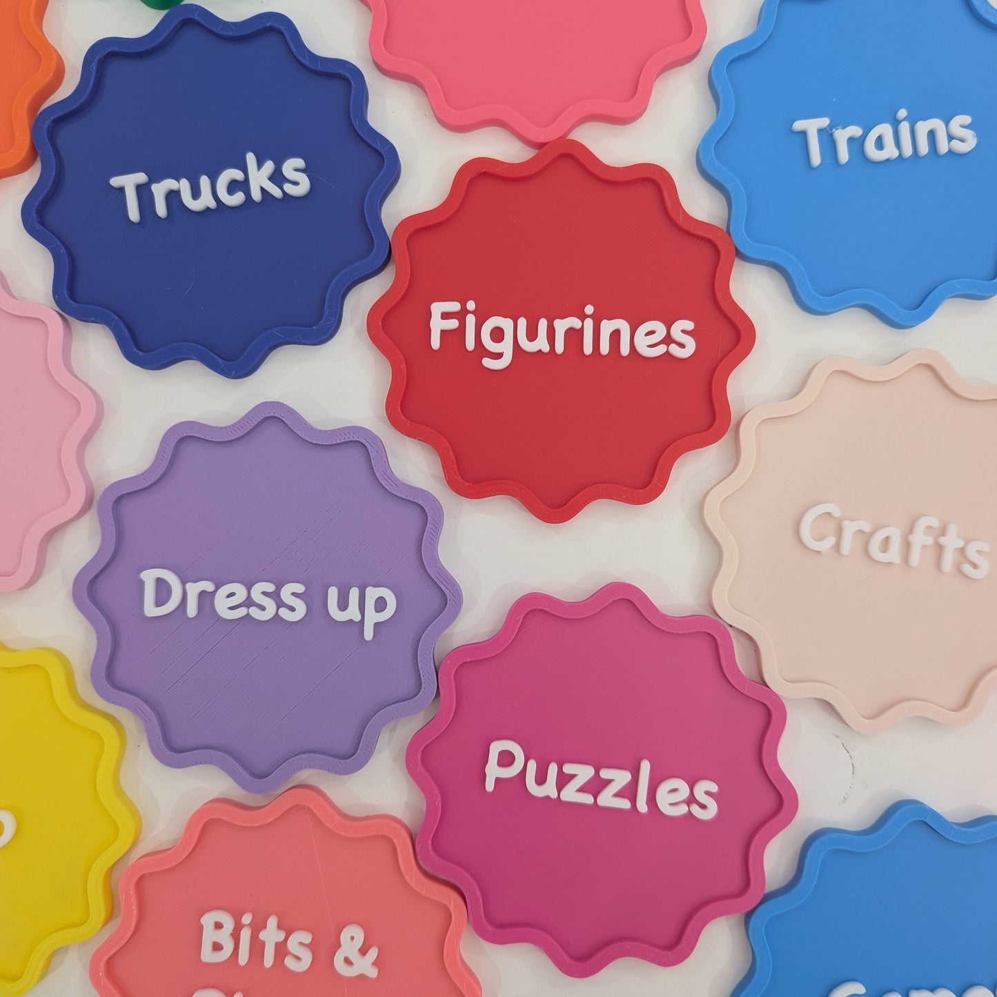 Colorful labels on a board with text indicating different categories of toys.
