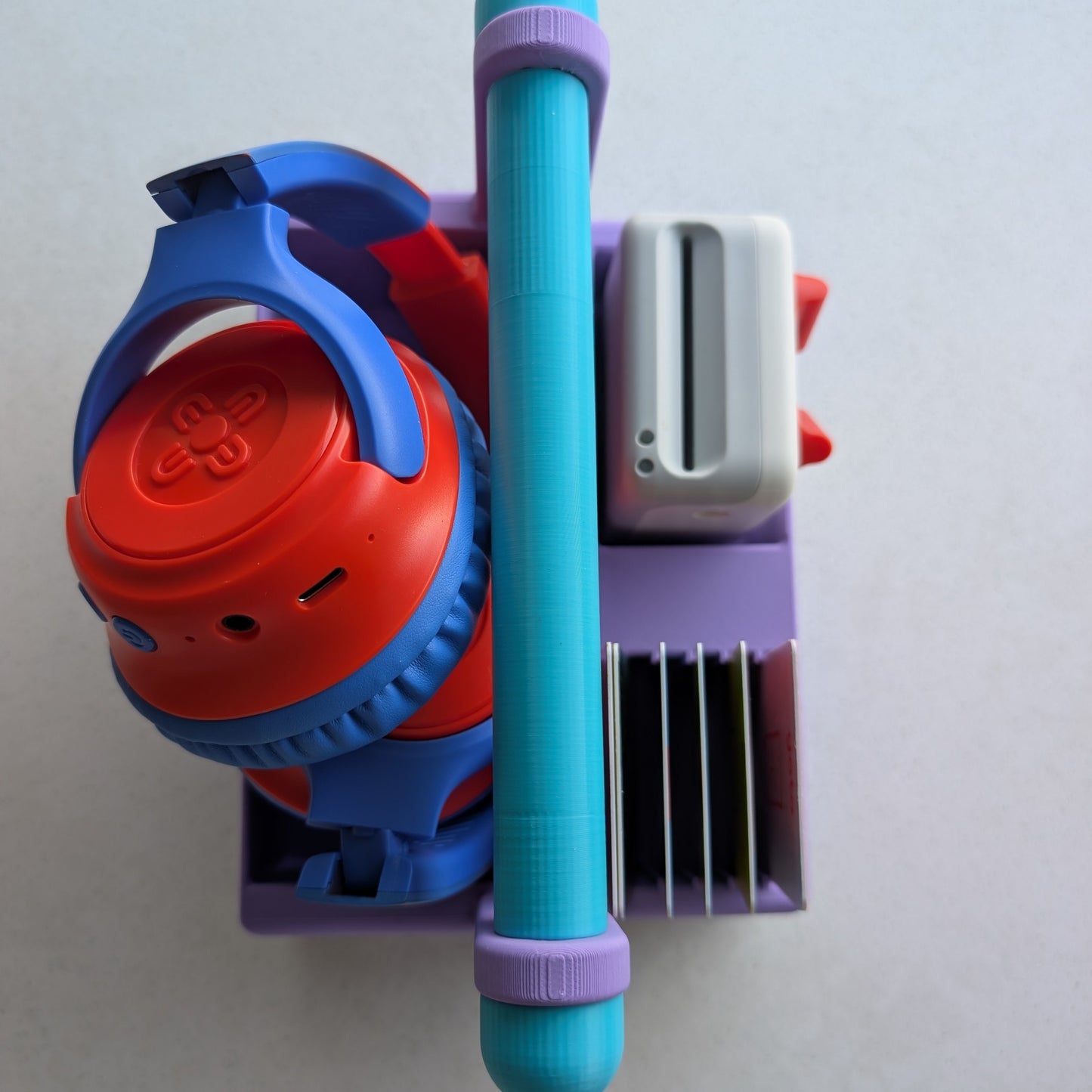 a basket holding yoto mini, headphones and yoto cards. 