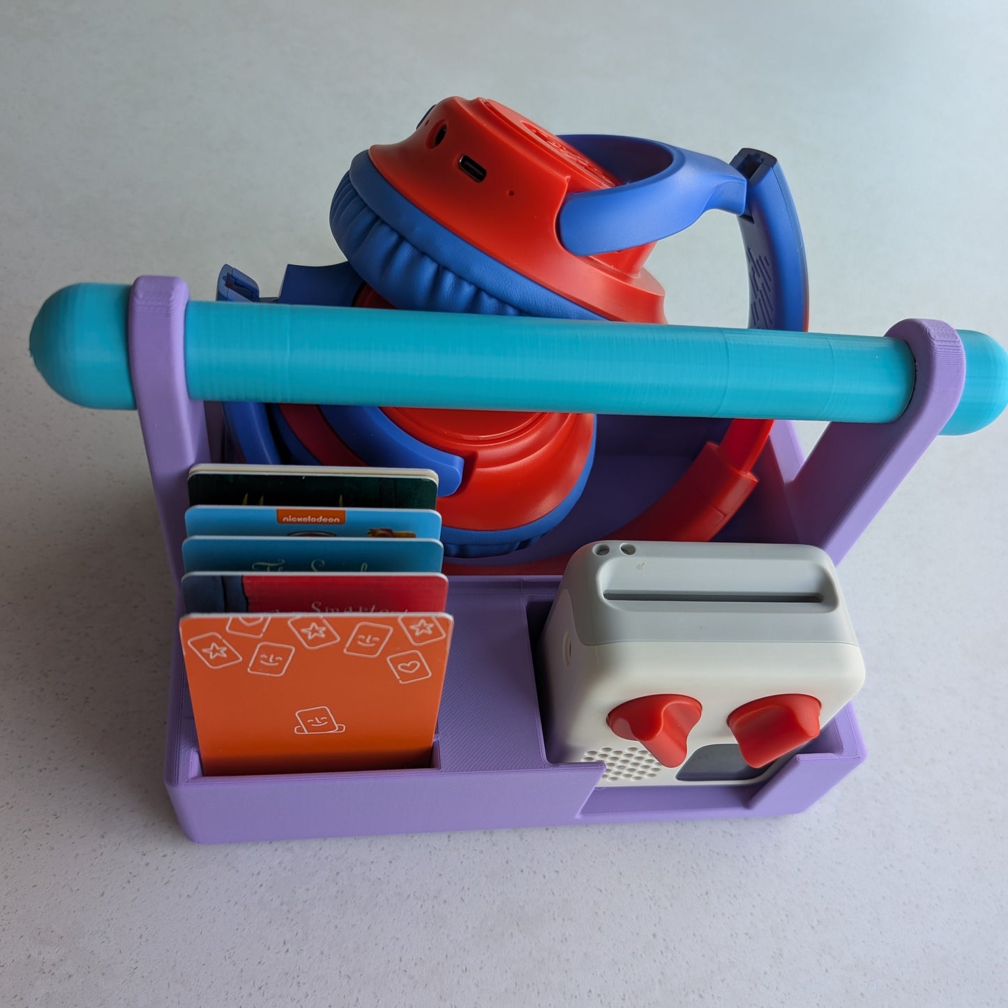 purple travel basket for the Yoto mini with cards and headphones